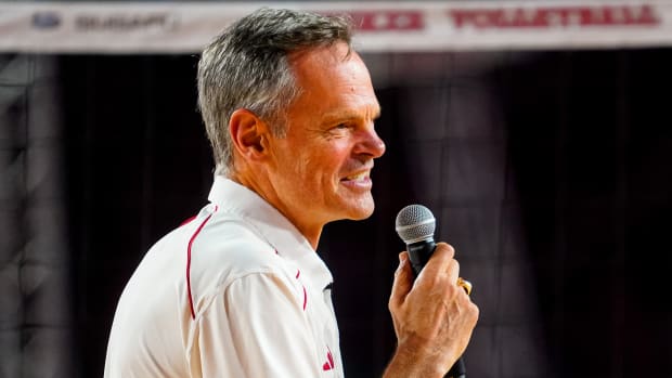 Nebraska volleyball coach John Cook speaks to the crowd after the Huskers' match against Omaha in Memorial Stadium in Lincoln.